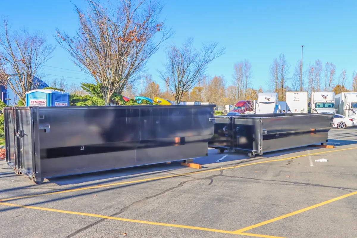 Professional dumpster rental service with roll-off container on residential driveway in Monett